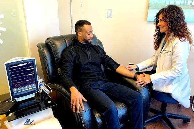 Dr. Ladan Eshkevari, PhD, CRNA, FAAN, founder of Avesta Ketamine and Wellness, with a patient